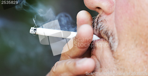 Image of Man smoking a cigarette