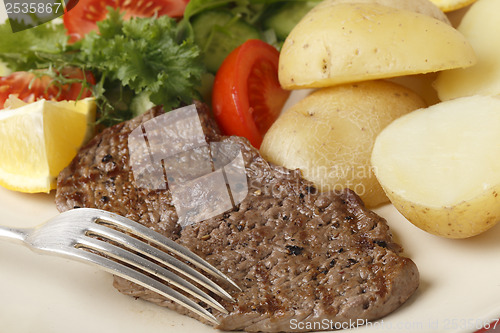 Image of Minute steak meal closeup with fork