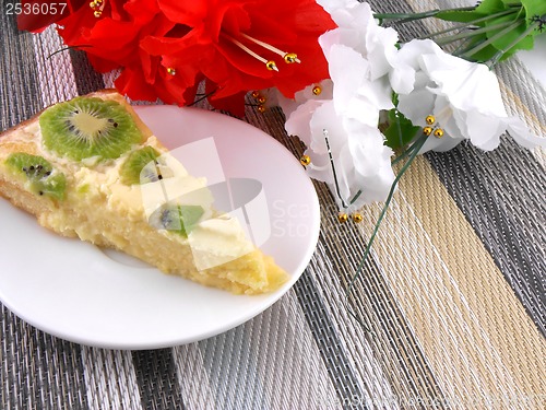 Image of cake with fruits with red and white flowers