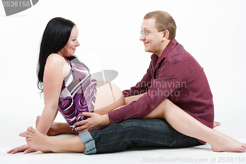 Image of Young happy couple. Husband and pregnant wife