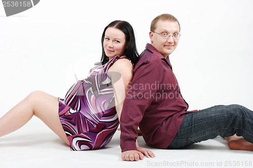 Image of Young happy couple. Husband and pregnant wife
