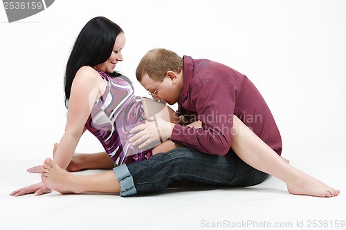 Image of Young happy couple. Husband and pregnant wife
