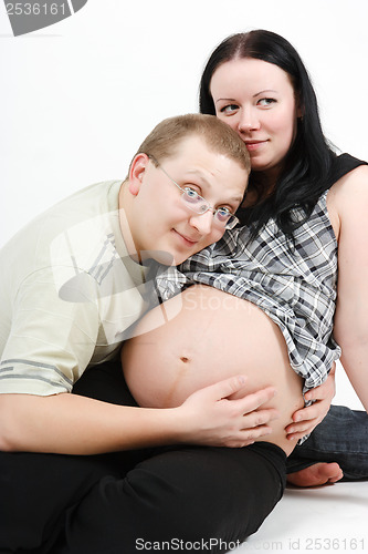 Image of Young happy couple. Husband and pregnant wife