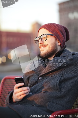 Image of Young man with smartphone