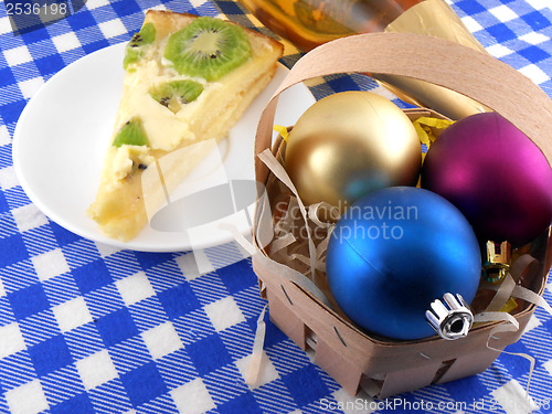 Image of Christmas decoration with christmas balls and sweet kiwi cake
