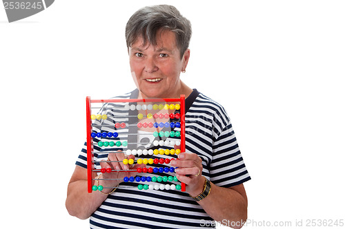 Image of Senior woman calculating with abacus