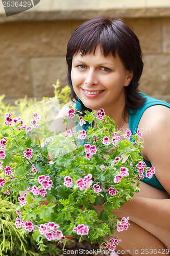 Image of happy smiling middle age woman gardening