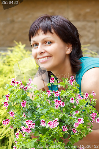 Image of happy smiling middle age woman gardening