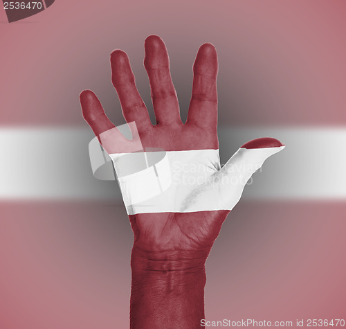 Image of Palm of a woman hand, painted with flag