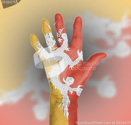 Image of Palm of a woman hand, painted with flag