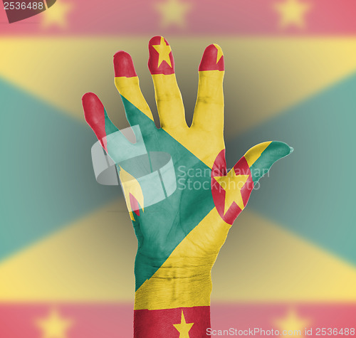 Image of Palm of a woman hand, painted with flag