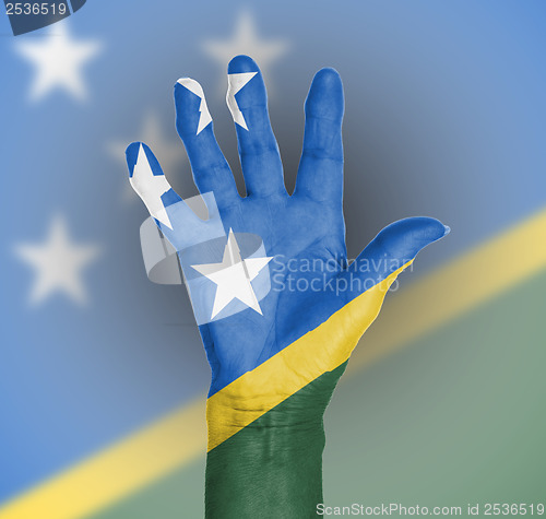 Image of Palm of a woman hand, painted with flag