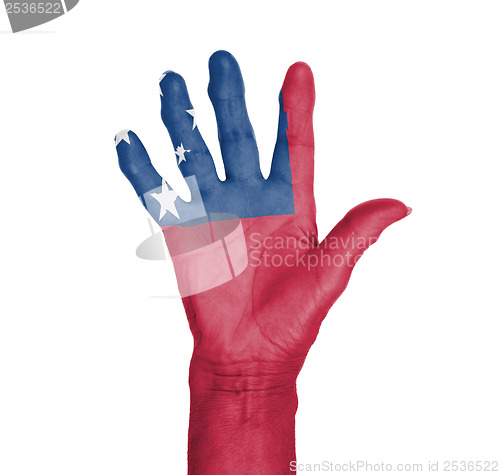 Image of Palm of a woman hand, painted with flag