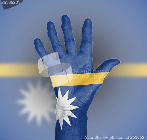 Image of Palm of a woman hand, painted with flag