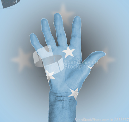 Image of Palm of a woman hand, painted with flag