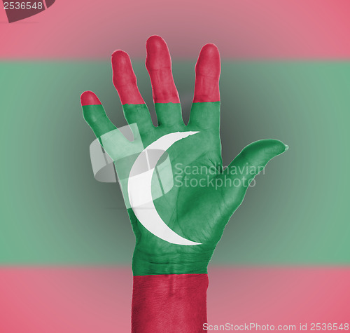 Image of Palm of a woman hand, painted with flag