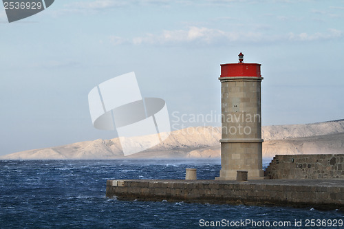 Image of Picture represents the lighthouse while blowing strong wind