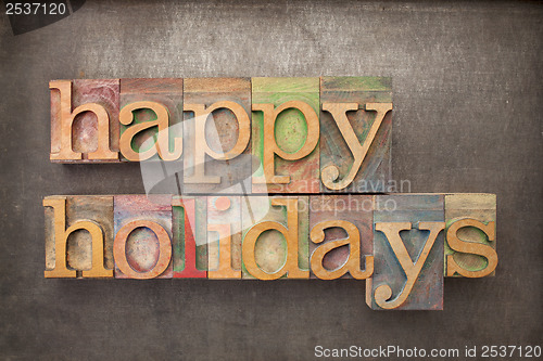 Image of happy holidays in wood type