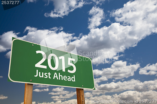 Image of 2015 Just Ahead Green Road Sign Over Clouds and Sky