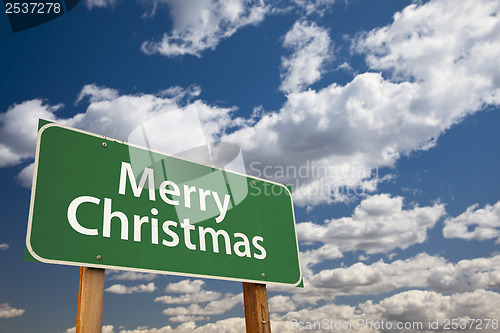 Image of Merry Christmas Green Road Sign Over Clouds and Sky