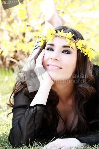 Image of Beautiful young woman lies on green grass