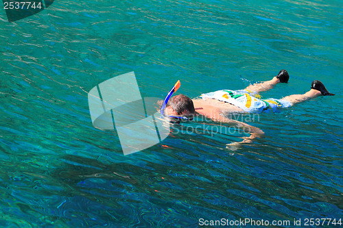 Image of Young man is snorkeling