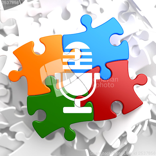 Image of Microphone Icon on Multicolor Puzzle.