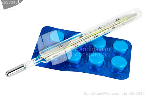 Image of Thermometer with pills isolated