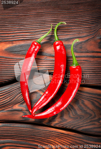 Image of Three red chili peppers