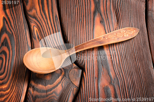 Image of Wooden spoon on the wooden background