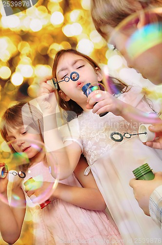 Image of holiday portrait of happy children against bright background