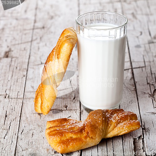 Image of glass of milk and two fresh baked buns