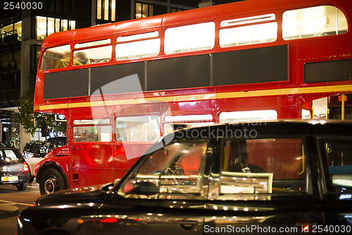 Image of Red vintage bus and classic style taxi in London. 