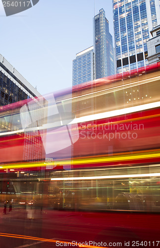 Image of Red Bus in motion in City of London