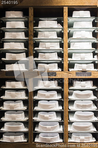 Image of Shirts stacked on a shelf in a store