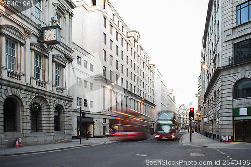 Image of Red Bus in motion in City of London