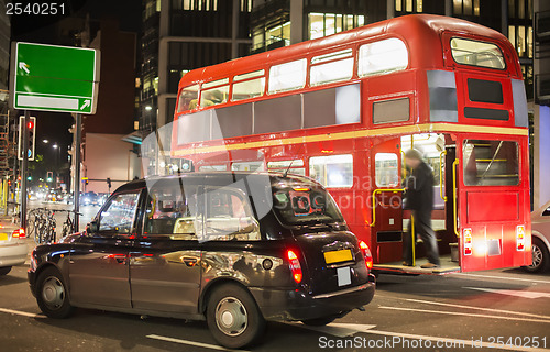 Image of Red vintage bus and classic style taxi in London. 