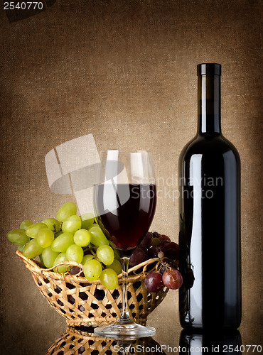 Image of Wine and grapes on a old background