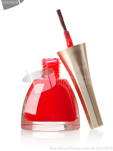 Image of Red nail polish and brush isolated