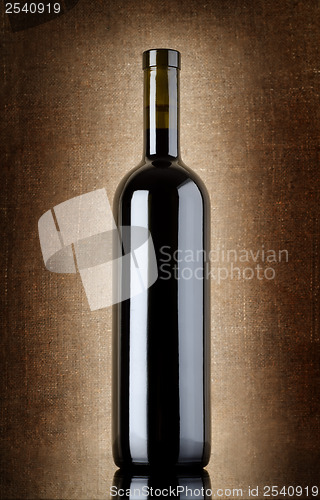 Image of Wine bottle on a old canvas