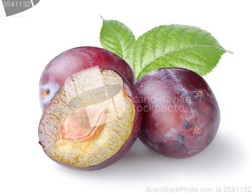 Image of Three plums with leaves