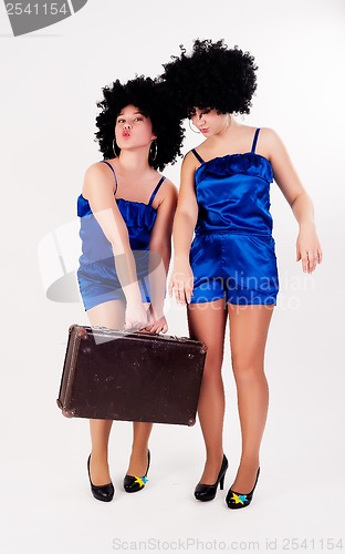 Image of Two pretty dancers with old suitcase