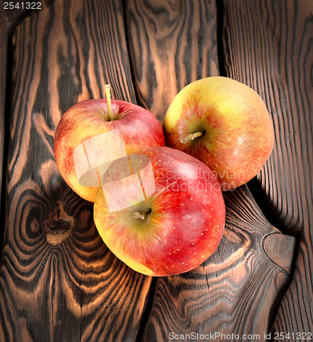 Image of Red apples on the wooden table