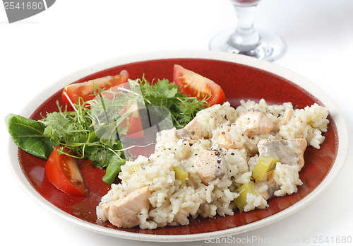 Image of Salmon risotto with a glass