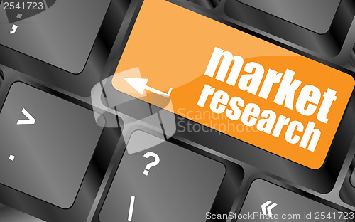 Image of key with market research text on laptop keyboard, business concept