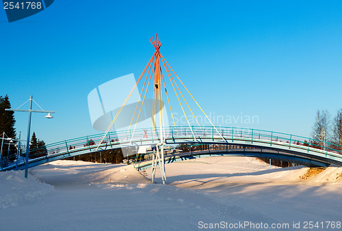 Image of small bridge on the background of a winter landscape