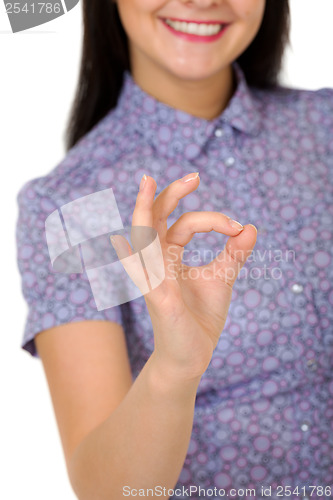 Image of smiling girl showing OK sign