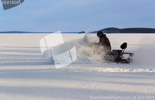 Image of man riding a snowmobile