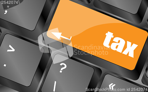 Image of tax word on laptop keyboard key, business concept
