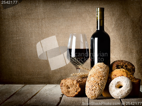 Image of Red wine and assortment of bread